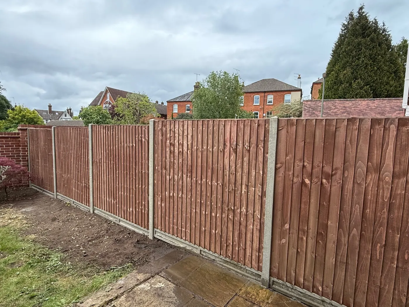 Feather edge fencing with concrete posts and gravel boards in Haslemere