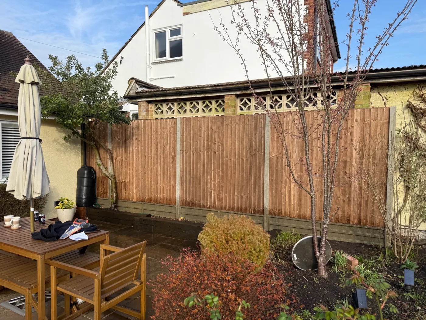 Closeboard fencing and gravel boards behind a patio in Haslemere